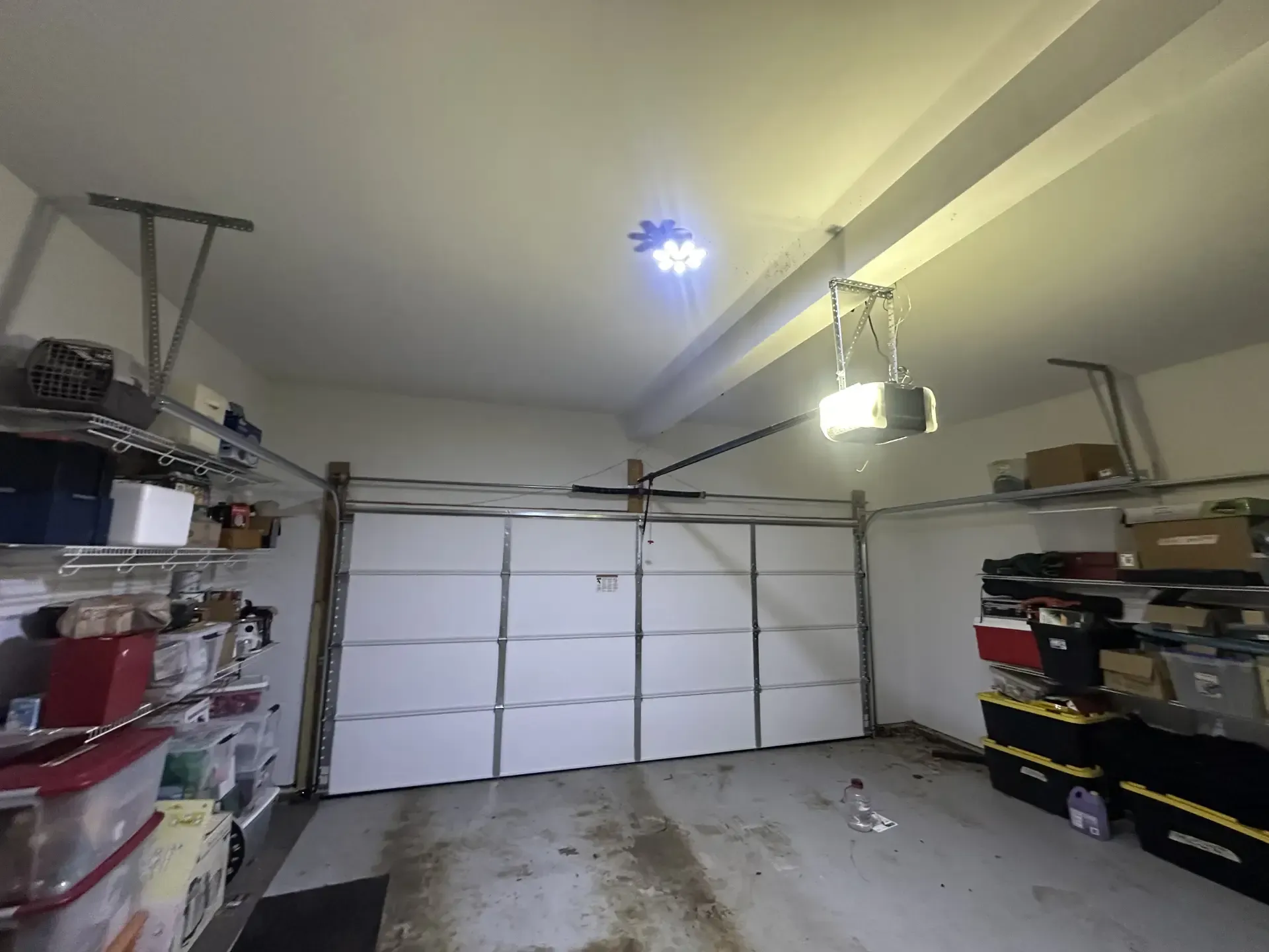 A garage filled with boxes and a garage door opener