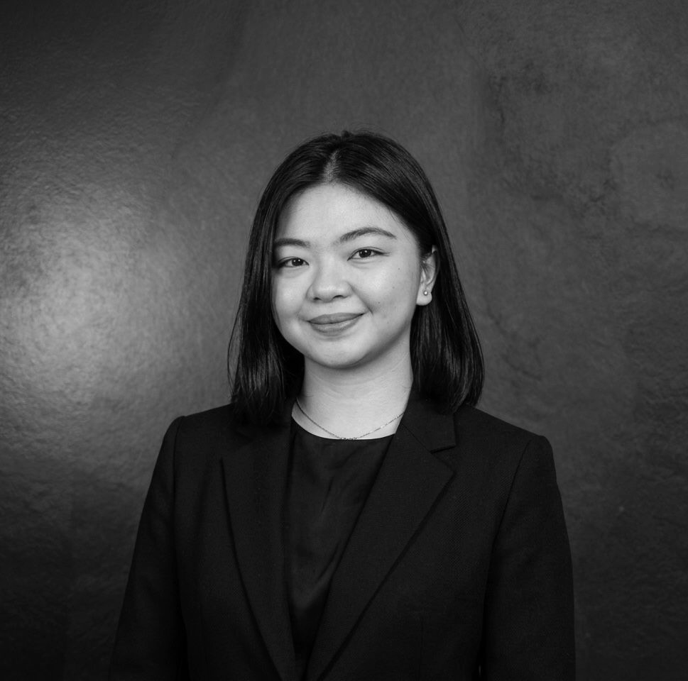 A group of men are standing in a row with their arms crossed.