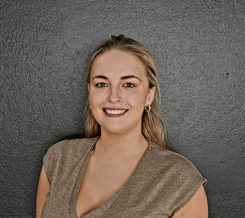 A group of men are standing in a row with their arms crossed.