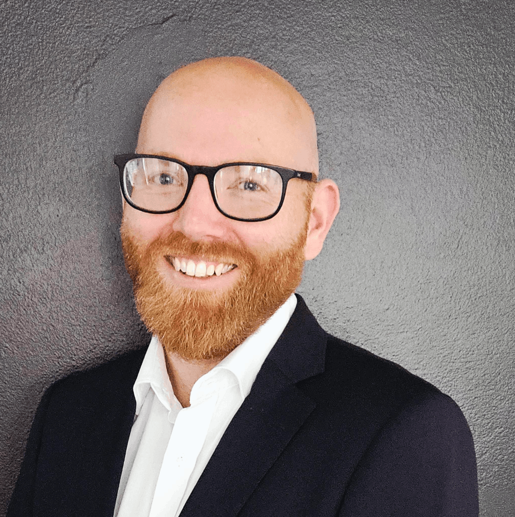 A group of men are standing in a row with their arms crossed.