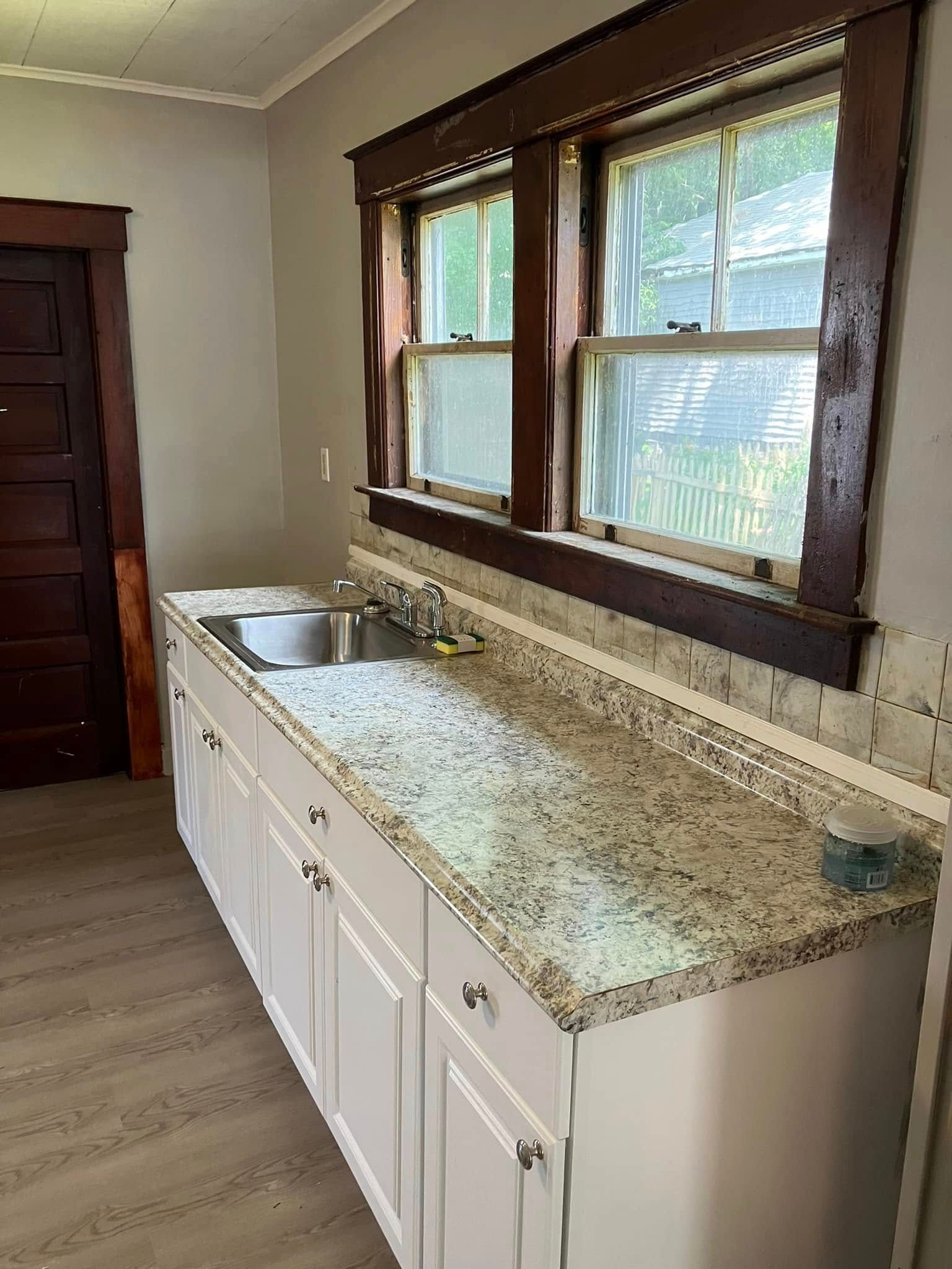 A kitchen with granite counter tops and a sink.