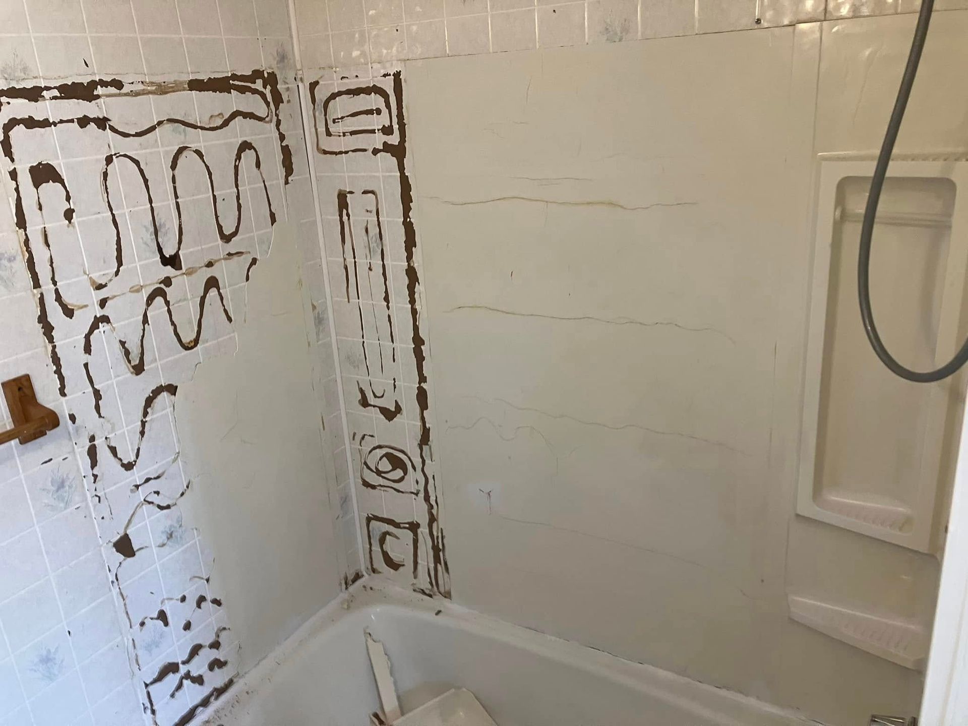 A bathroom with a bathtub and a shower.