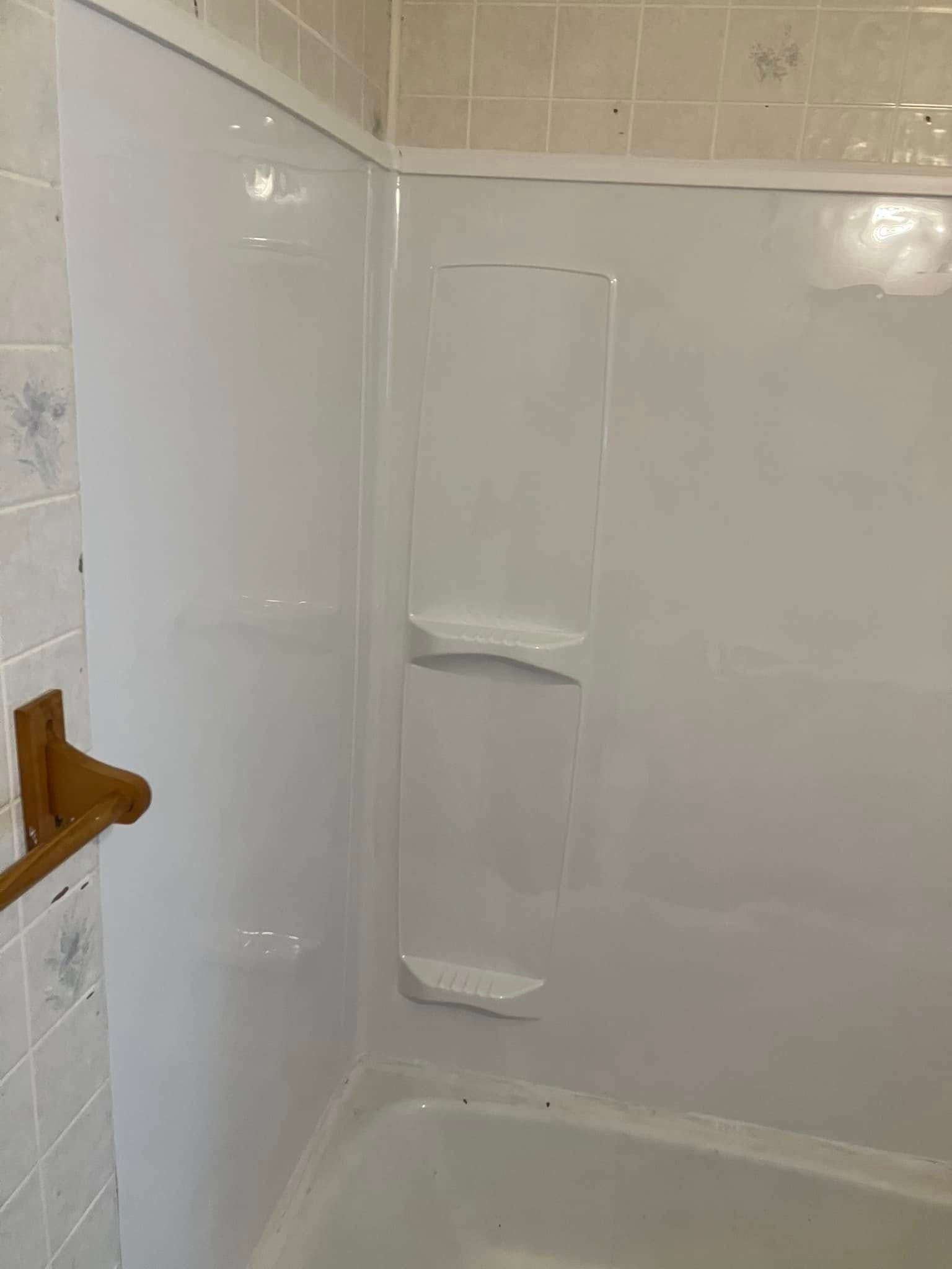 A bathroom with a bathtub and a shower stall.