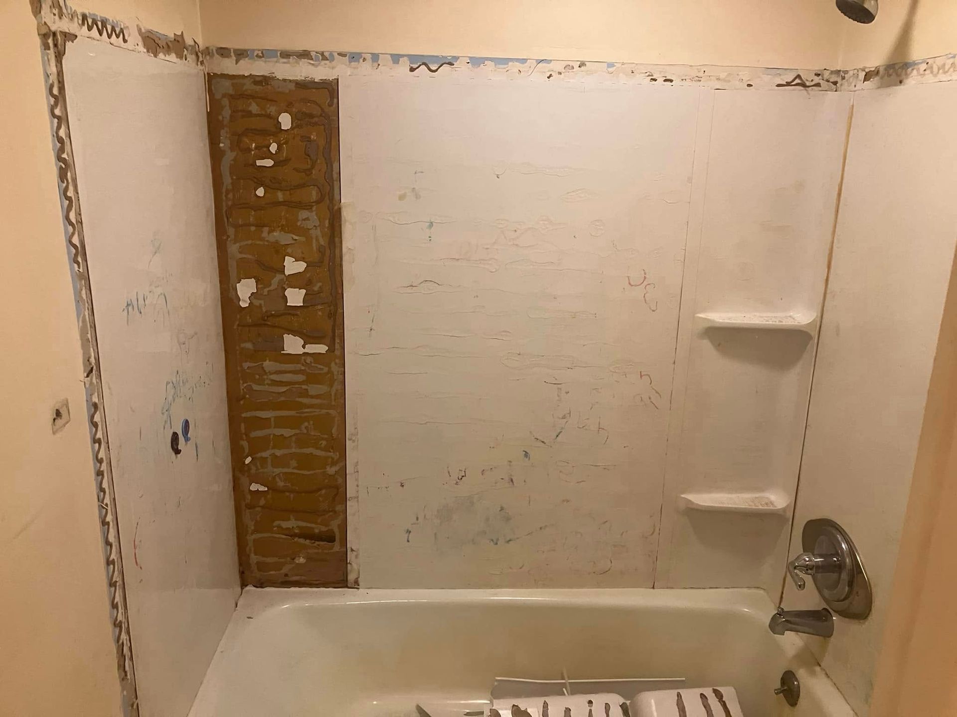 A bathroom with a bathtub and a shower.