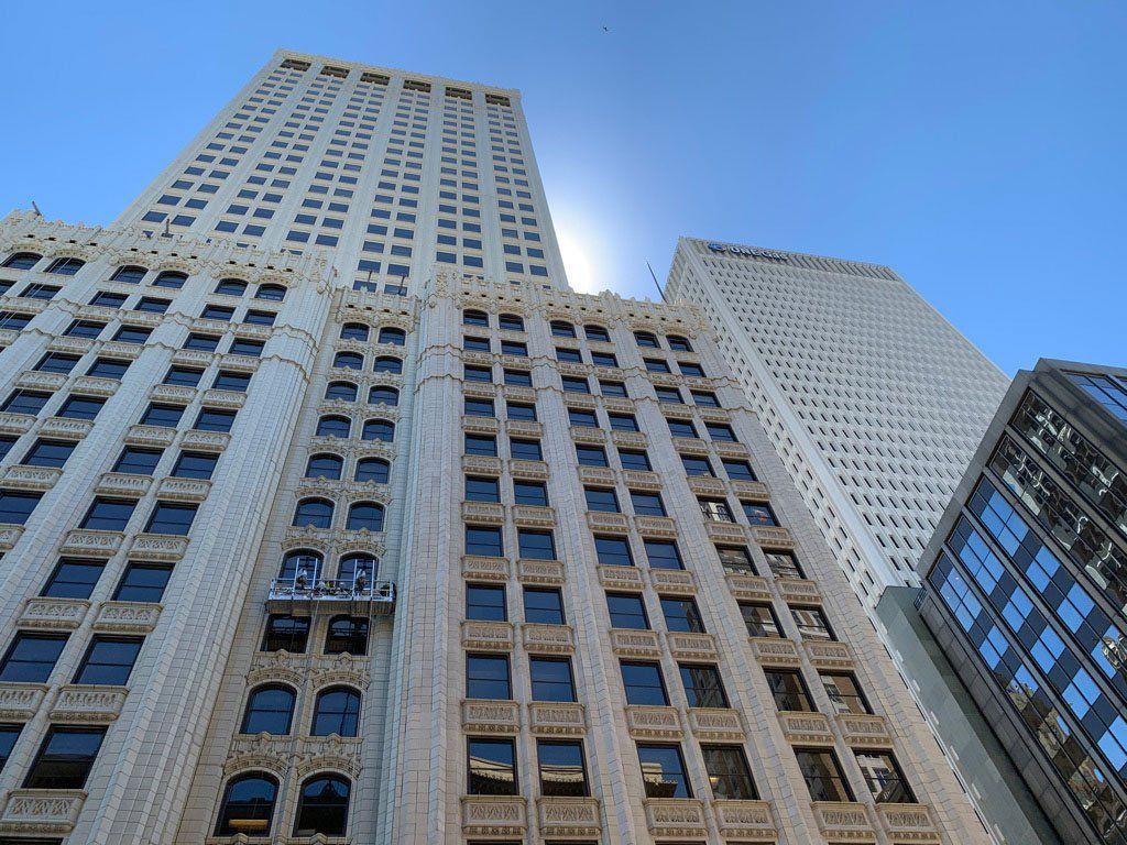 Looking up at a tall building with a blue sky in the background