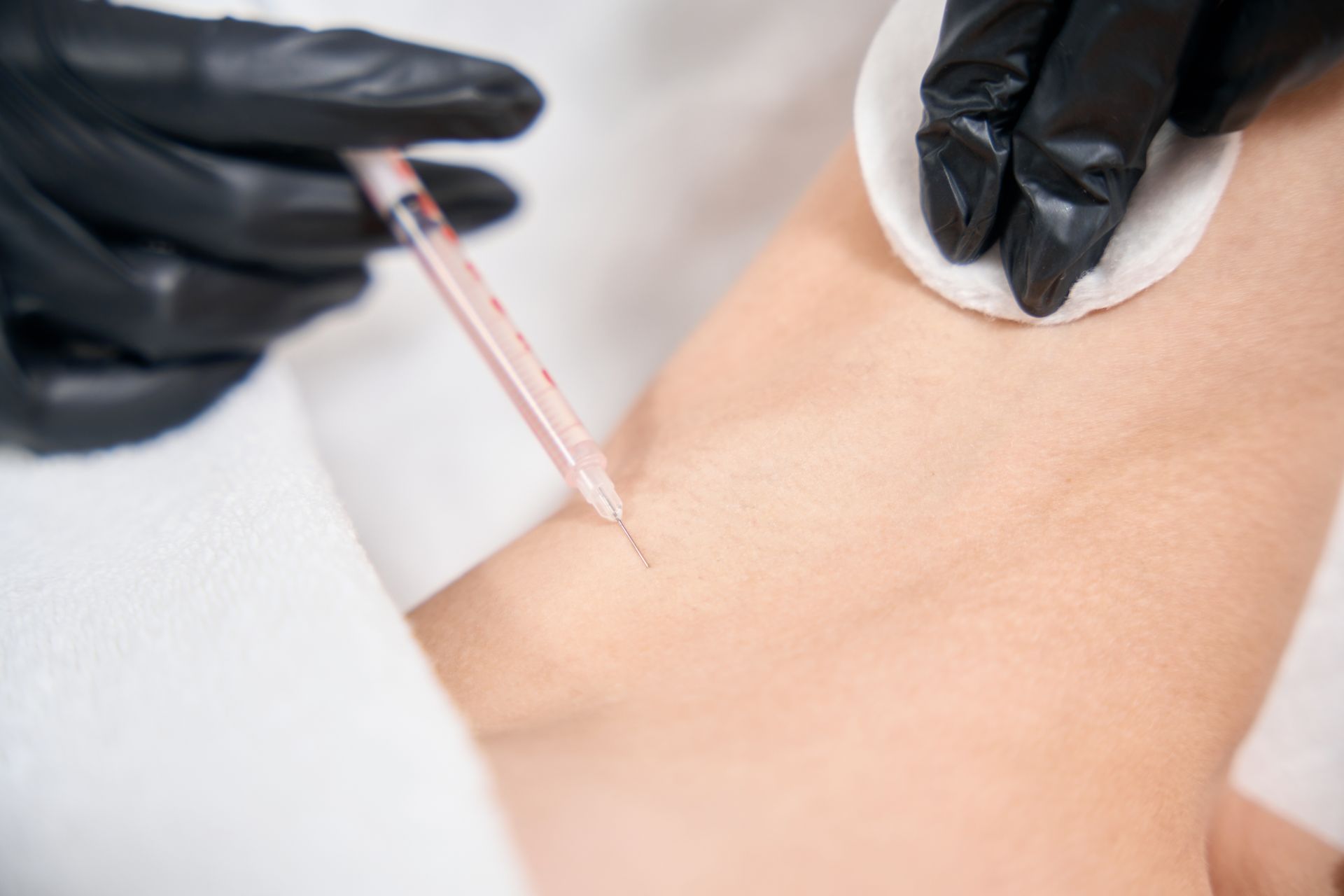A person is getting an injection in their arm.