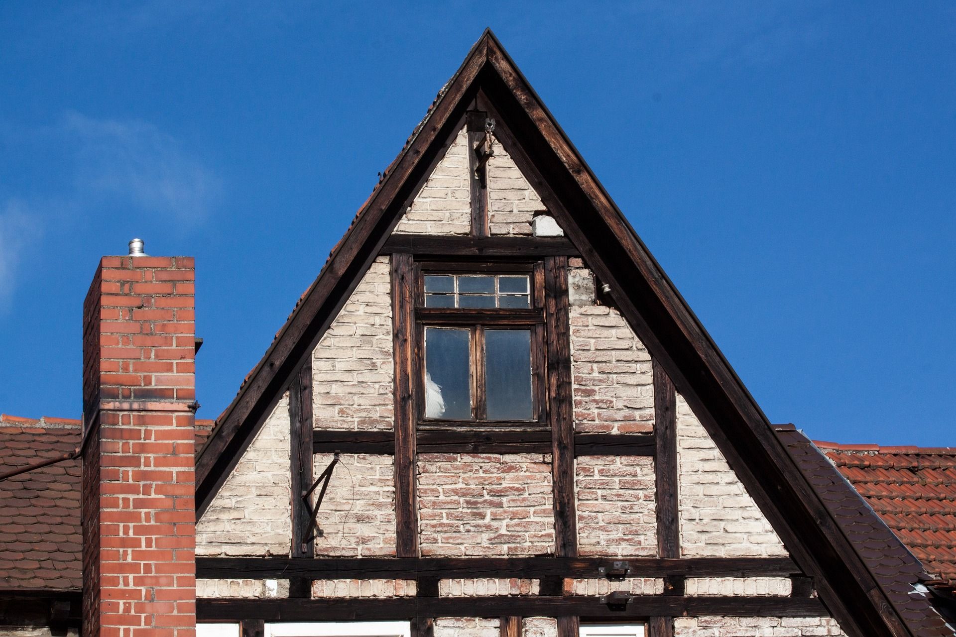 A Brick Building With A Triangle Shaped Roof