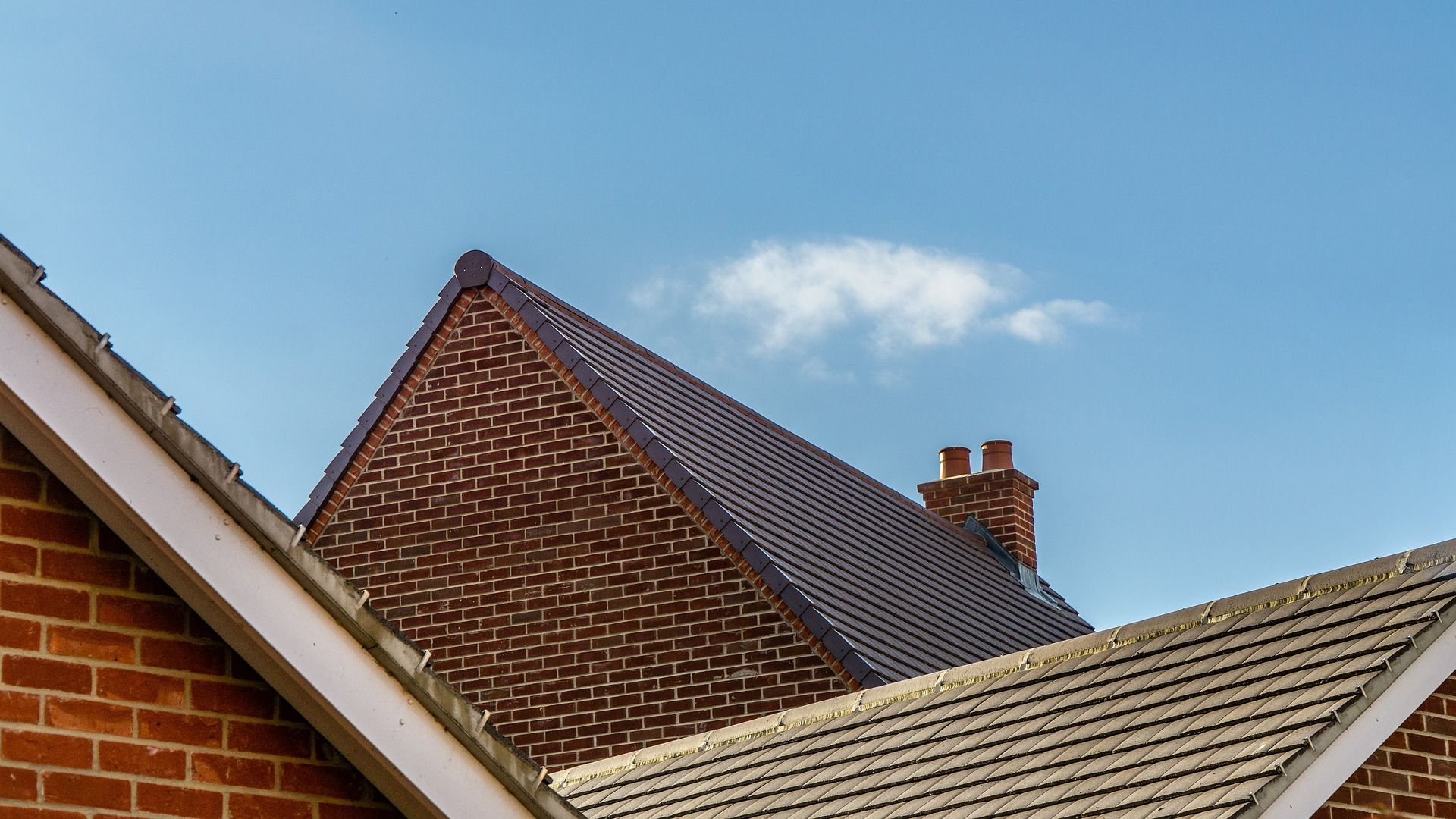 A Brick Building With A Chimney On The Roof