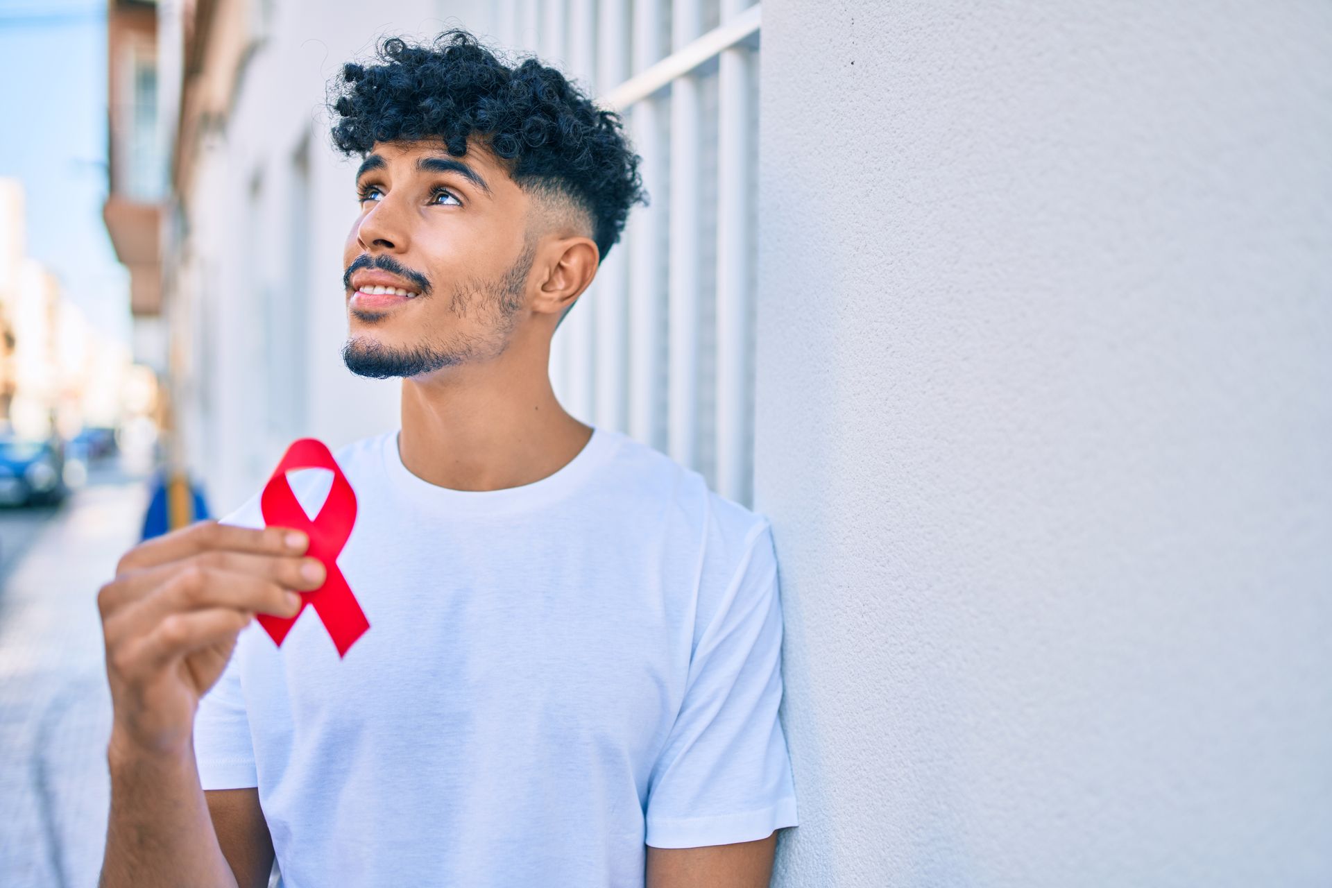 man hold ribbon for HIV in Houston, TX