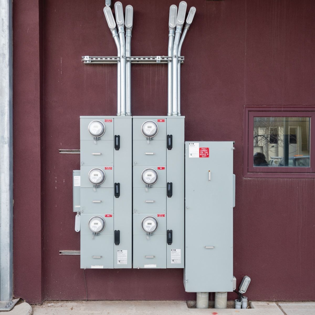A row of electrical panels on the side of a building