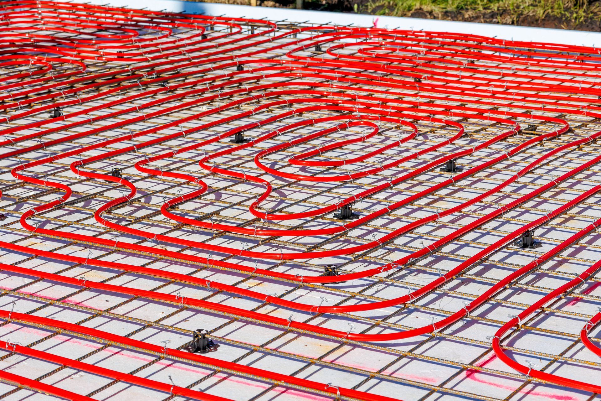 Underfloor heating system with red pipes on construction site. Underfloor heating system with red pipes on construction site.