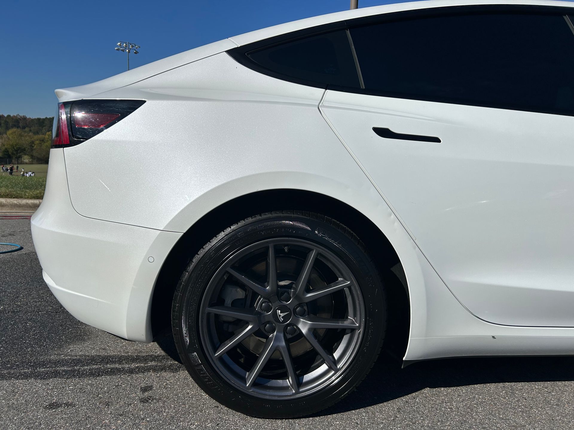 Tan truck with black wheel and tire.