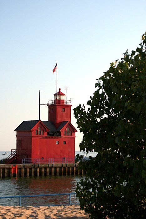 Big Red Lighthouse flying American flag in Holland, Michigan.