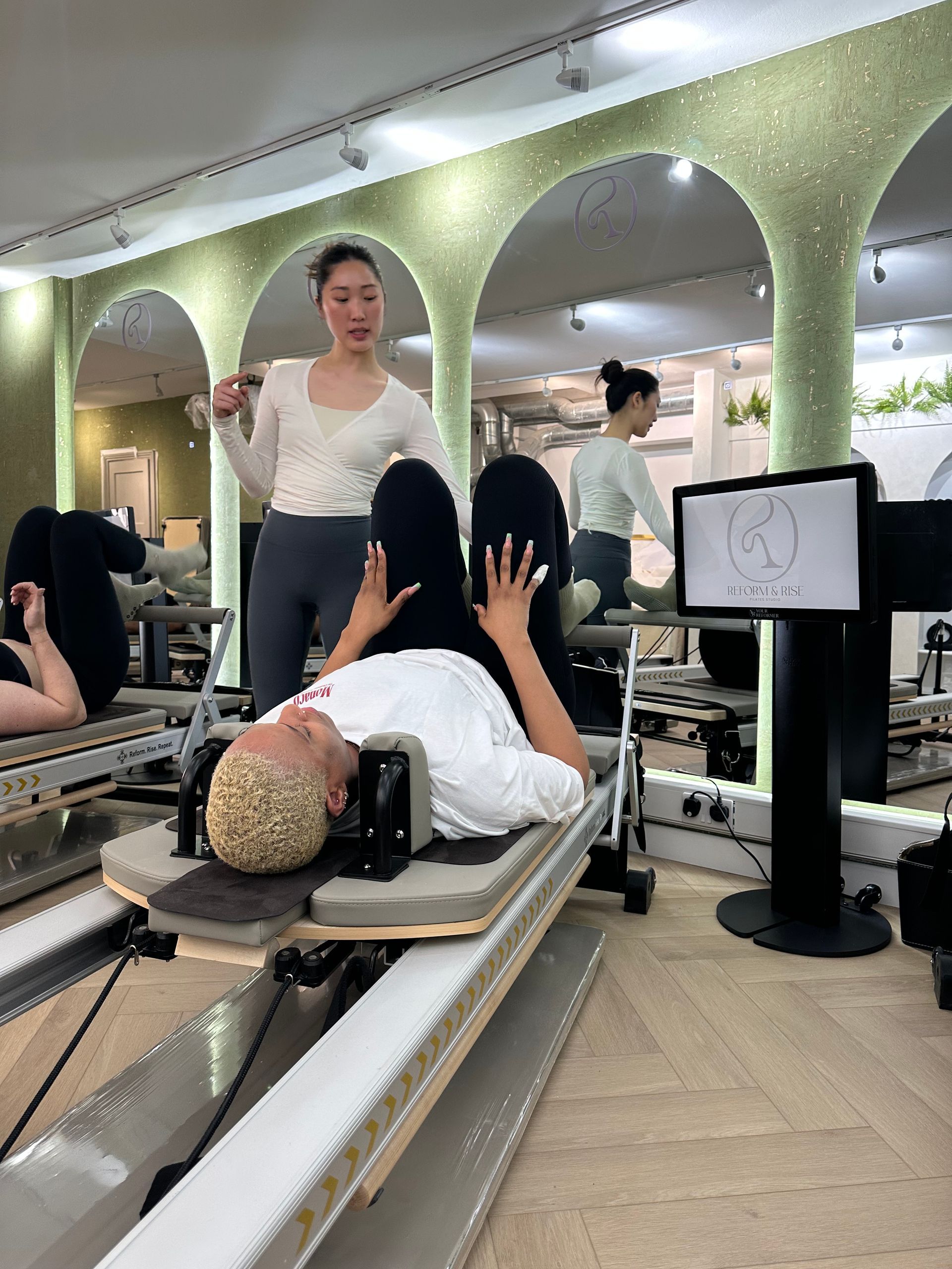 Pilates class in session at Reform & Rise Pilates boutique studio East London