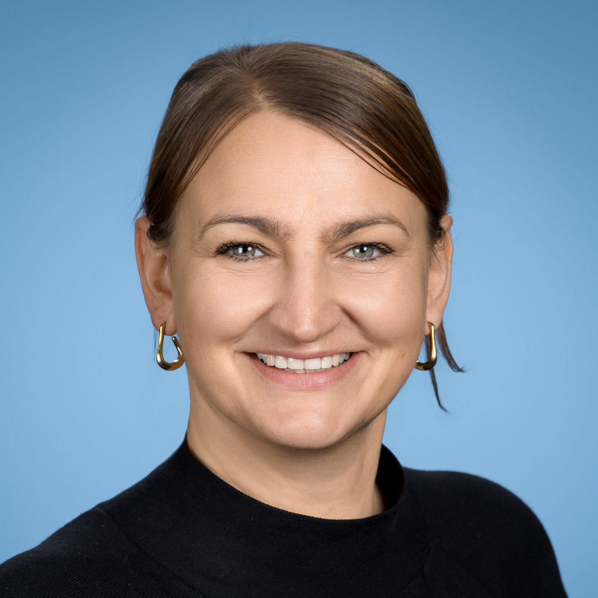 Eine graue, einfarbige Silhouette von Kopf und Schultern einer Person vor weißem Hintergrund.