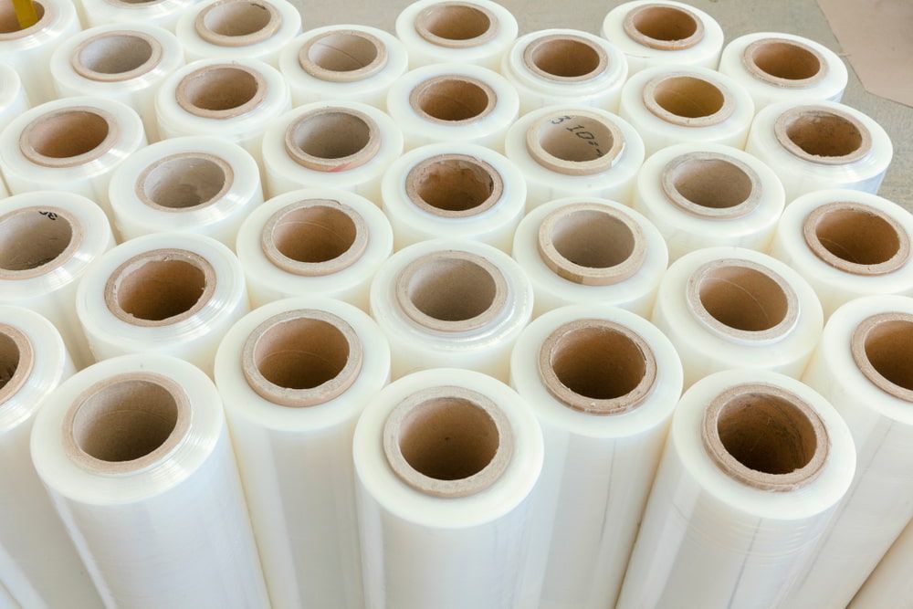Rolls of clear plastic wrap on cardboard cores, stacked.