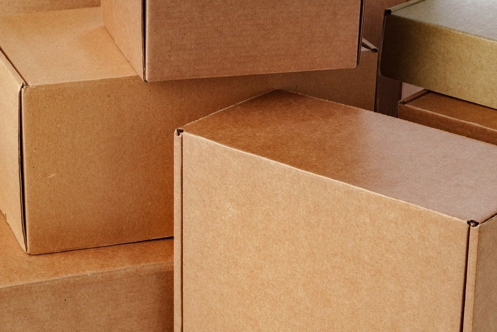 Pile of stacked brown cardboard boxes.