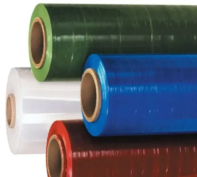 Four rolls of colored stretch wrap: clear, green, blue, and red-brown.