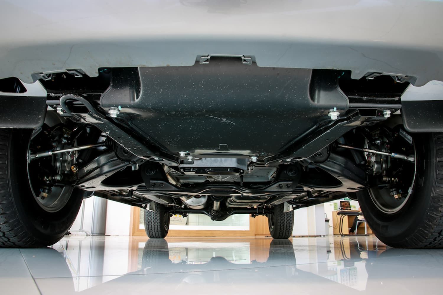 The Underside of A Car Is Shown in A Garage — AJ Automotive Services Bowral in Bowral, NSW