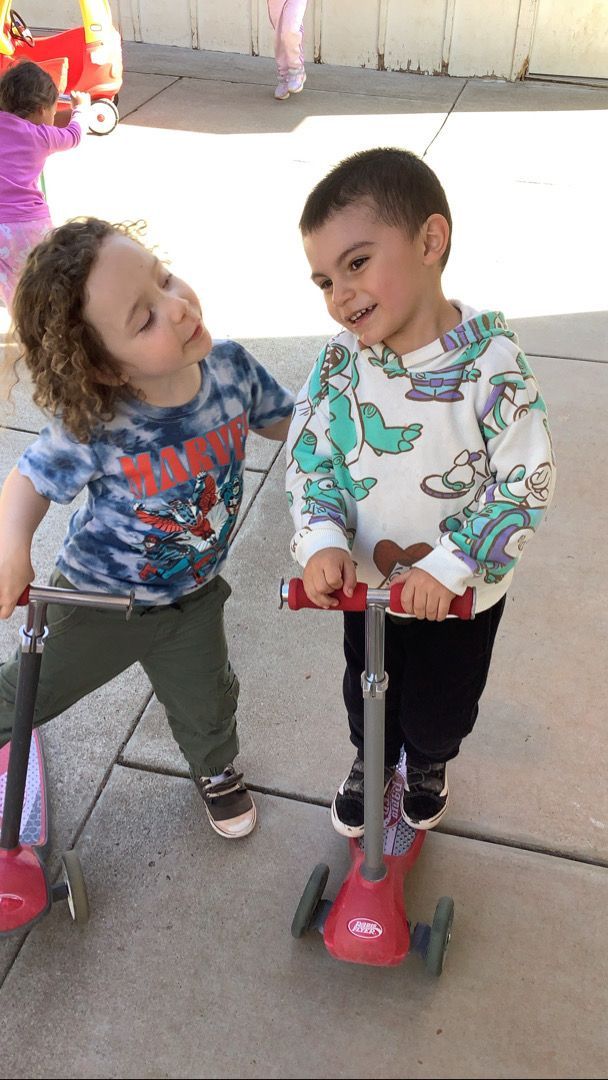 A boy wearing a shirt that says ' mario ' on it