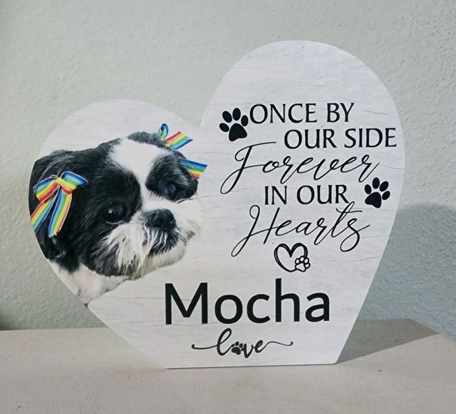 Heart-shaped sign with a photo of a dog named Mocha and the text.