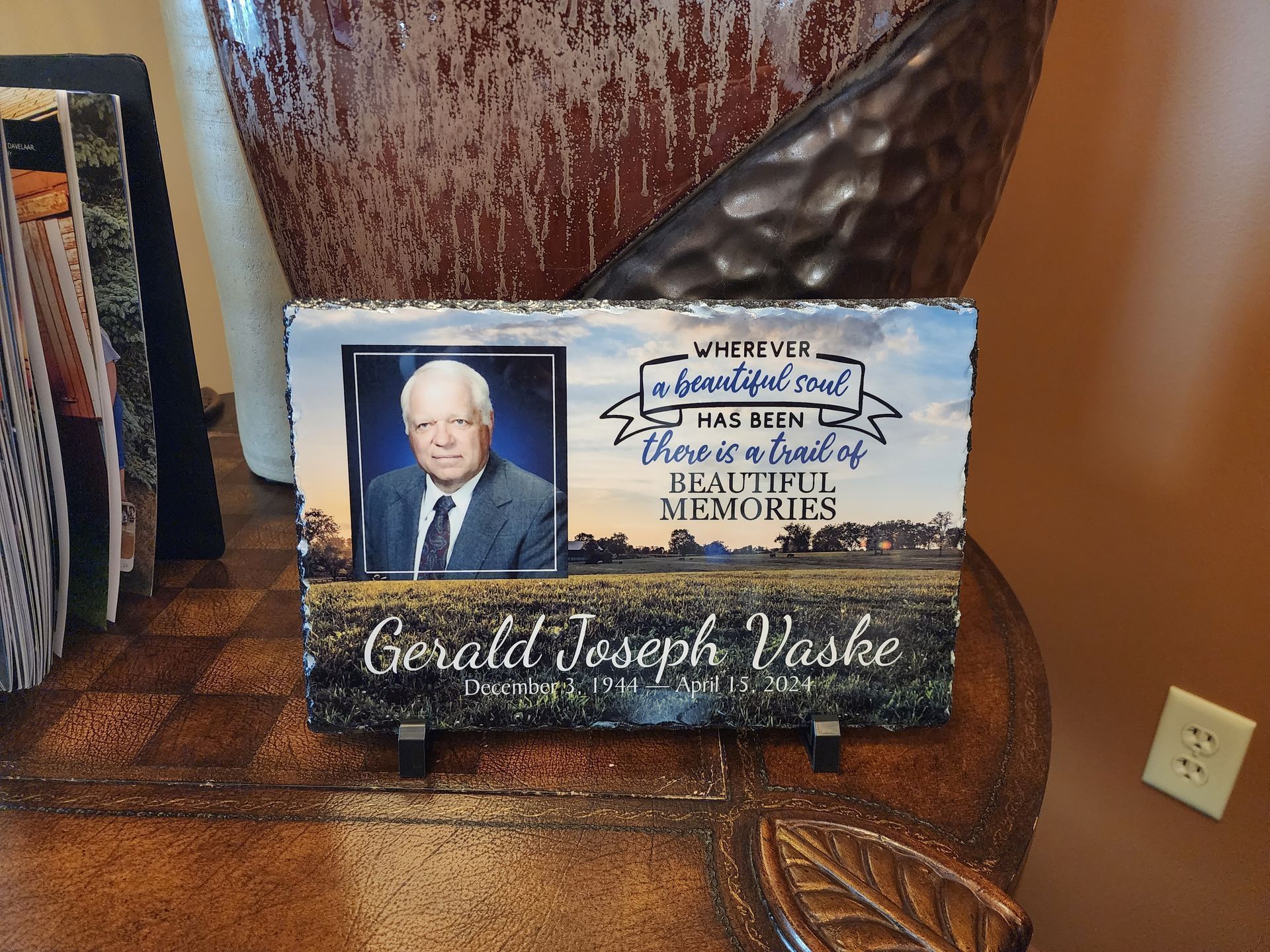 Memorial plaque with photo of Gerald Joseph Vaske, landscape backdrop, quote.