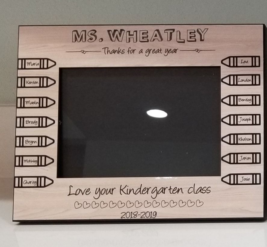 Wooden frame engraved for Ms. Wheatley, with names on crayons and a message of thanks.