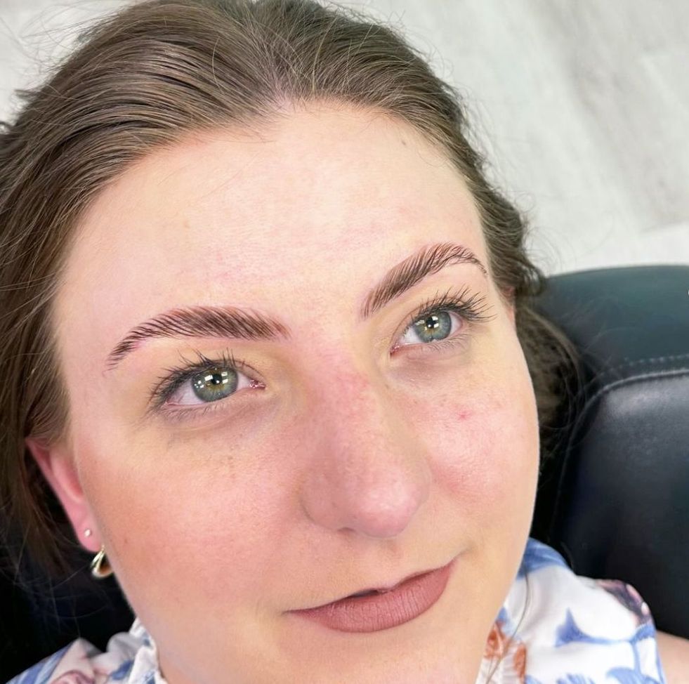 A close up of a woman 's face after eyebrow lamination treatment.