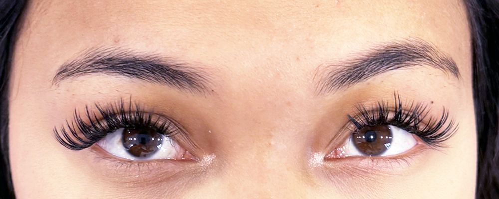 A close up of a woman 's eyes and eyebrows before a microblading treatment.
