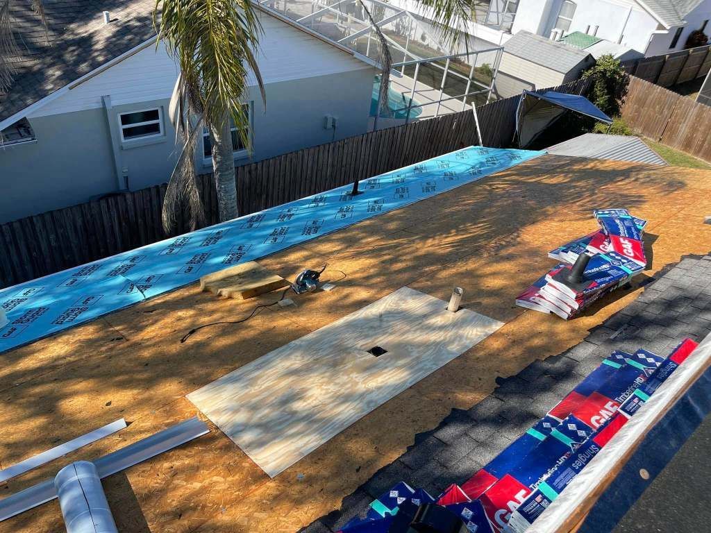 An aerial view of a roof being installed on a house.