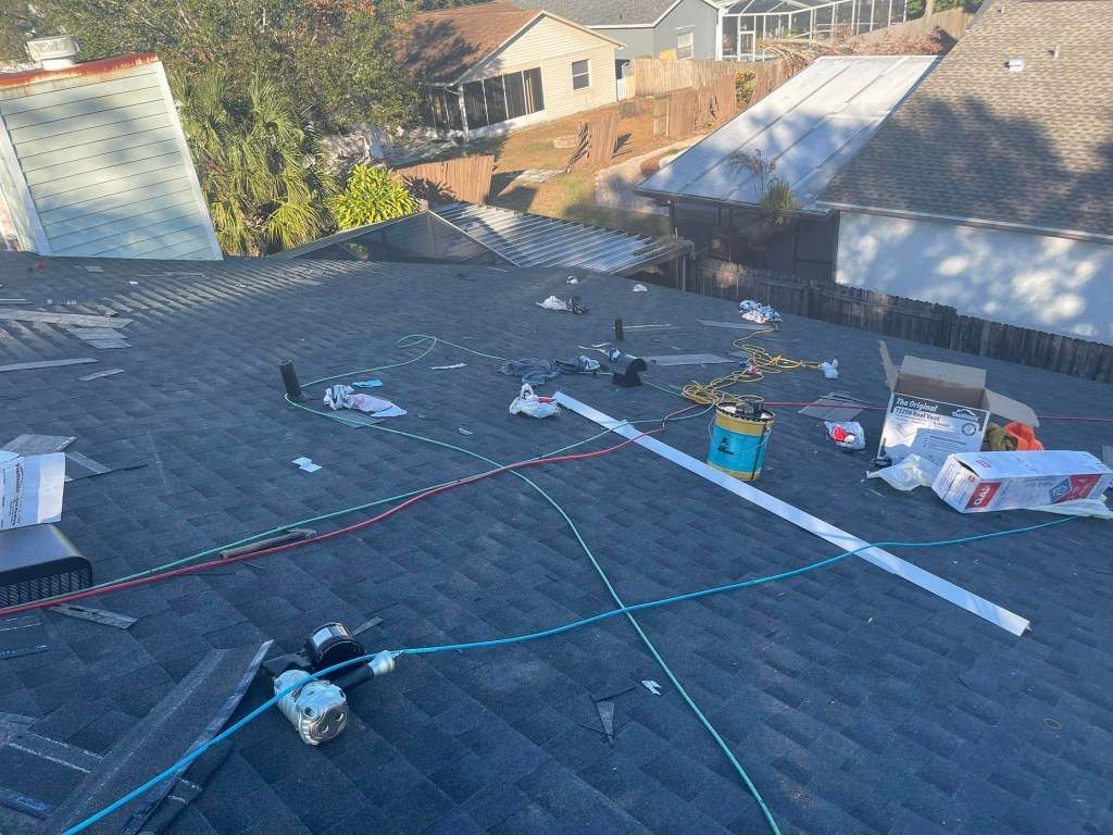 A roof with a lot of junk on it is being repaired.