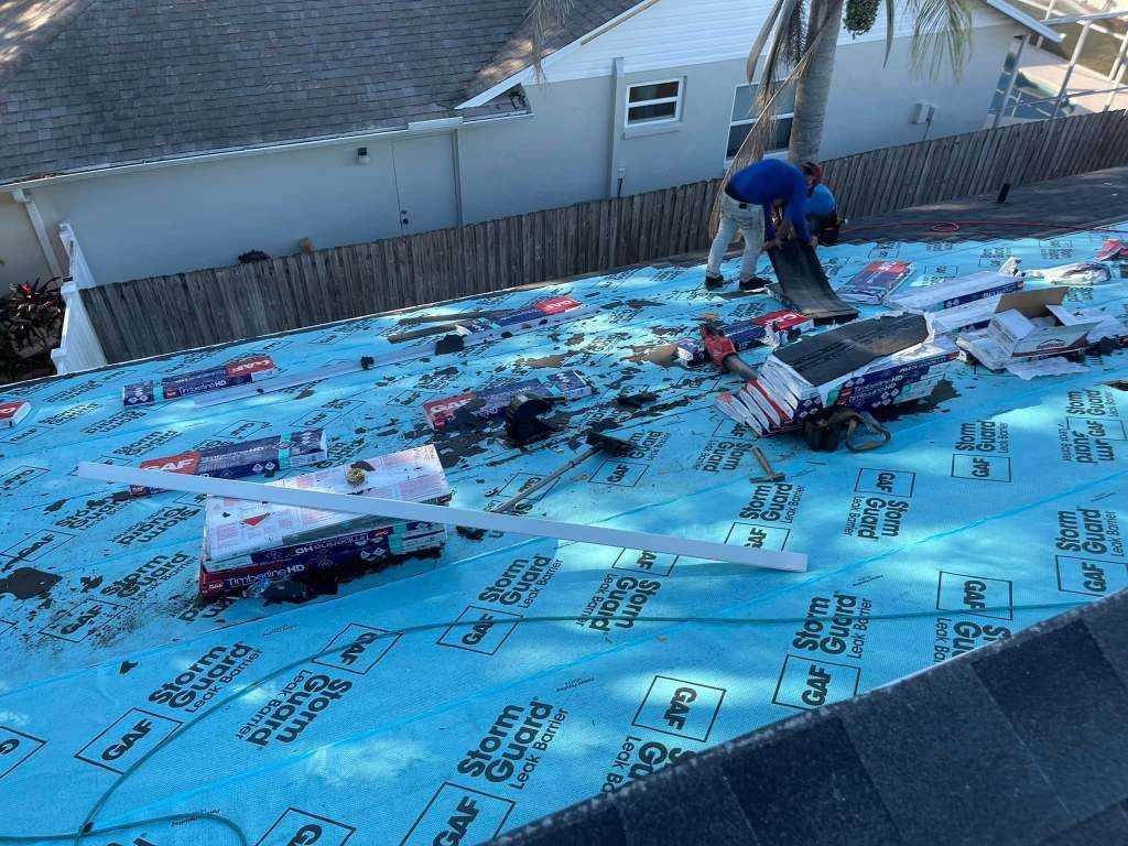 A man is working on the roof of a house.