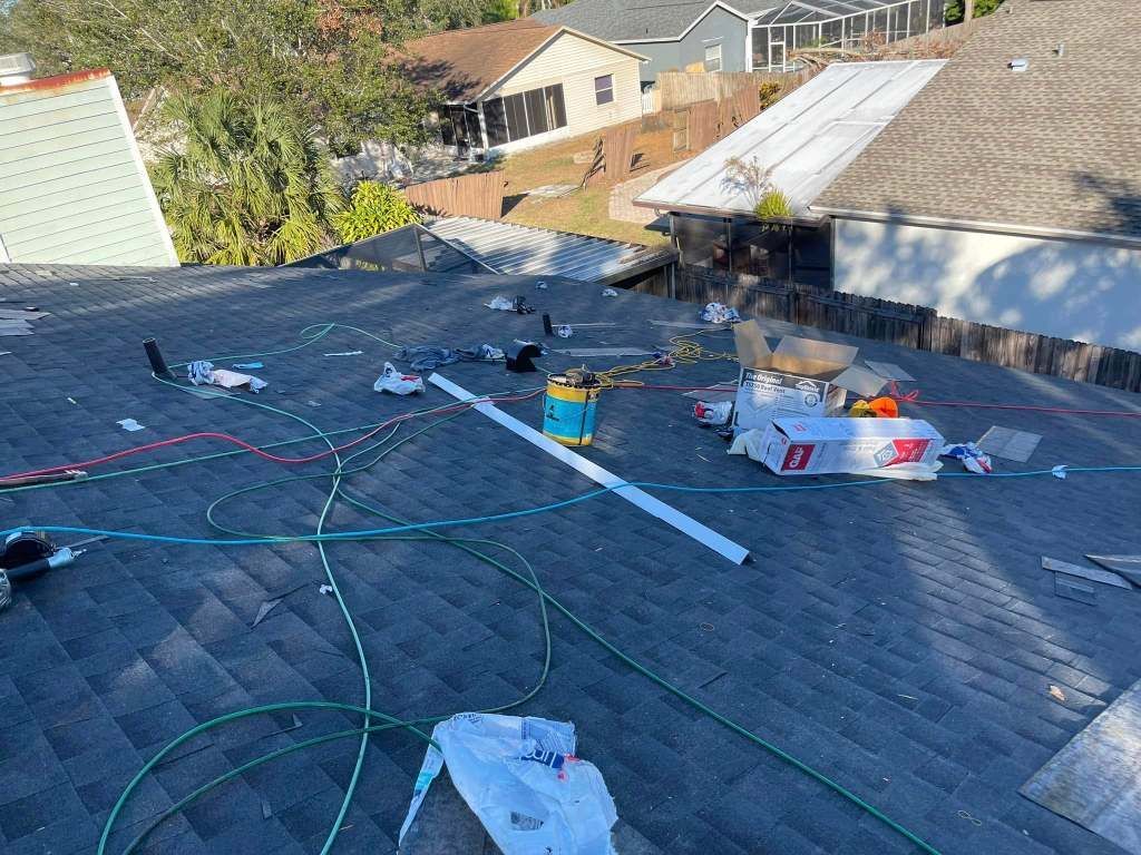 A roof with a lot of tools on it is being repaired.