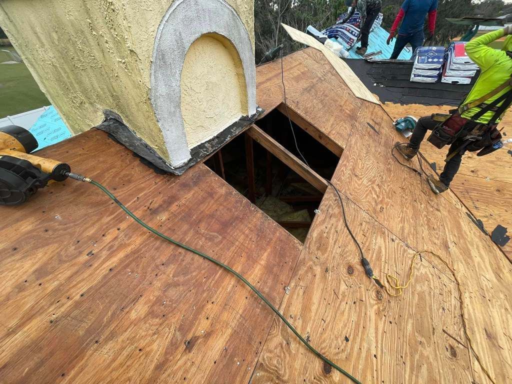 A group of people are working on a wooden roof.