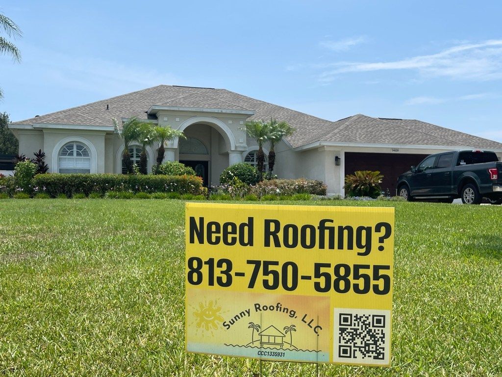 A sign in front of a house that says `` need roofing ? ''