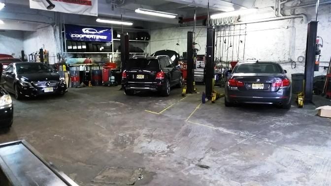 Cars in a car repair shop with lifts and tools. | Bovan’s Auto Services