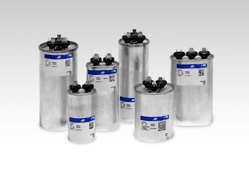 A group of capacitors of different sizes are lined up in a row