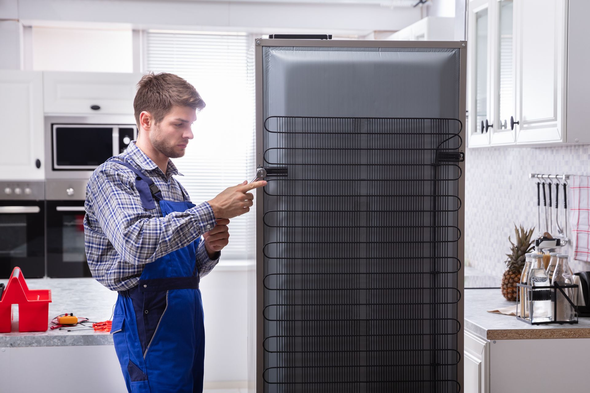 technician repairing a fridge