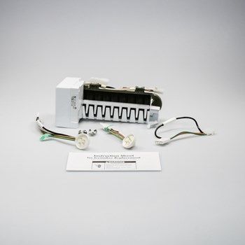 A white ice maker is sitting on top of a white table.