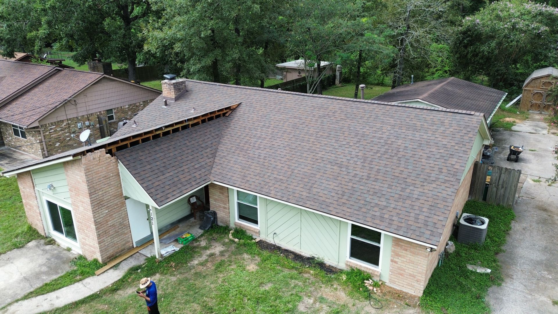 An aerial view of a house with a new roof.