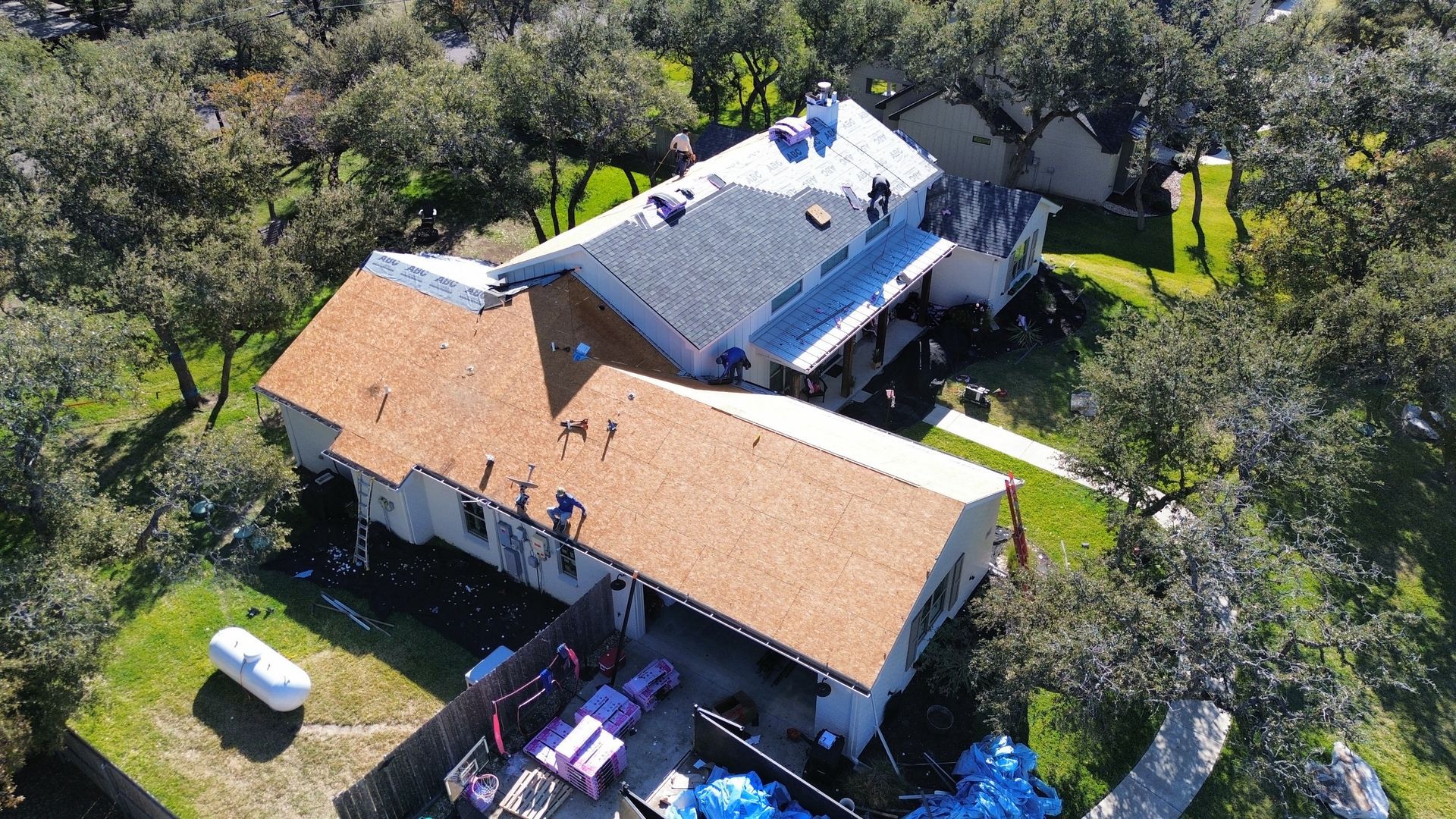 An aerial view of a house with a roof being installed.