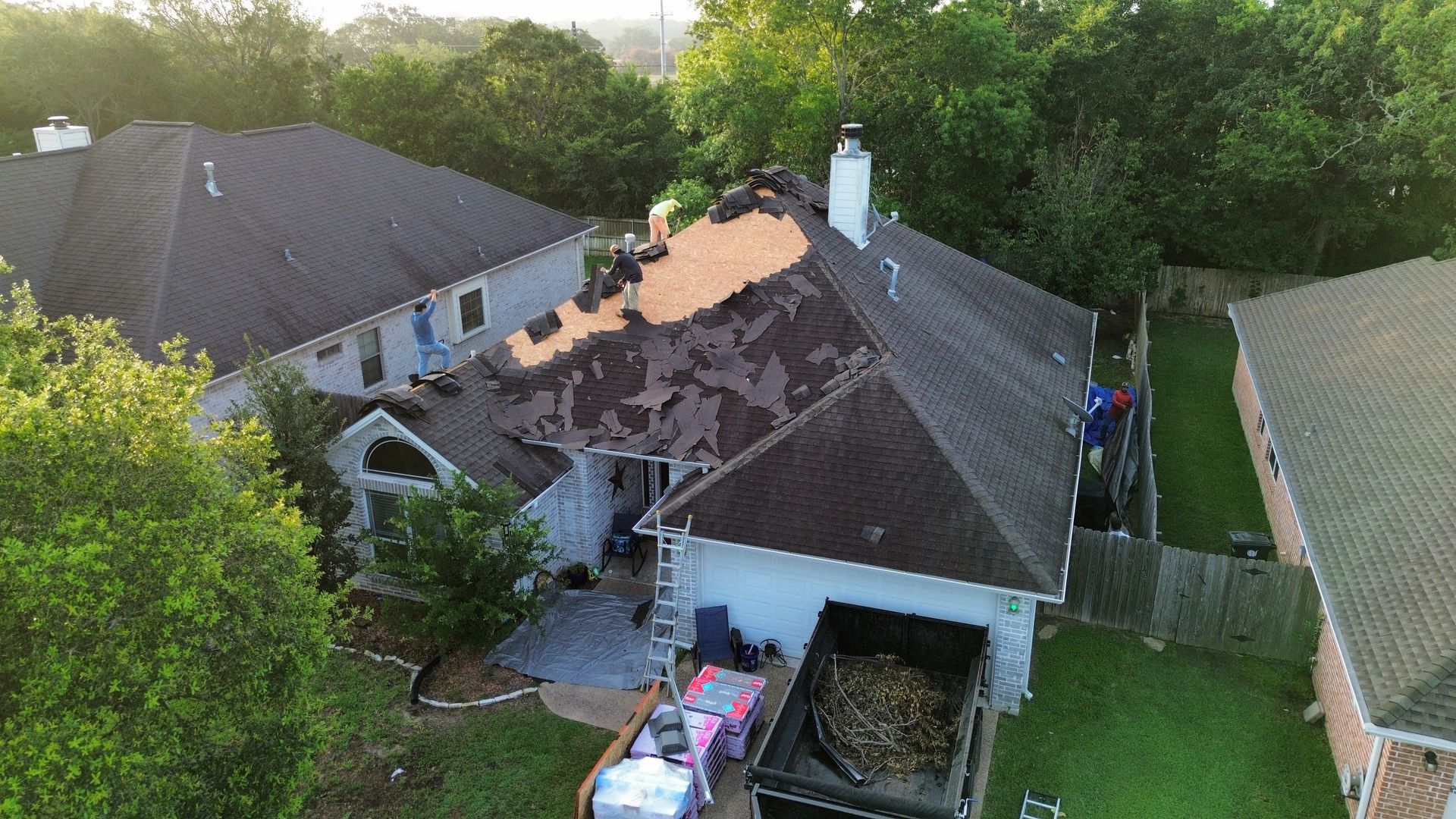 An aerial view of a house with a black roof