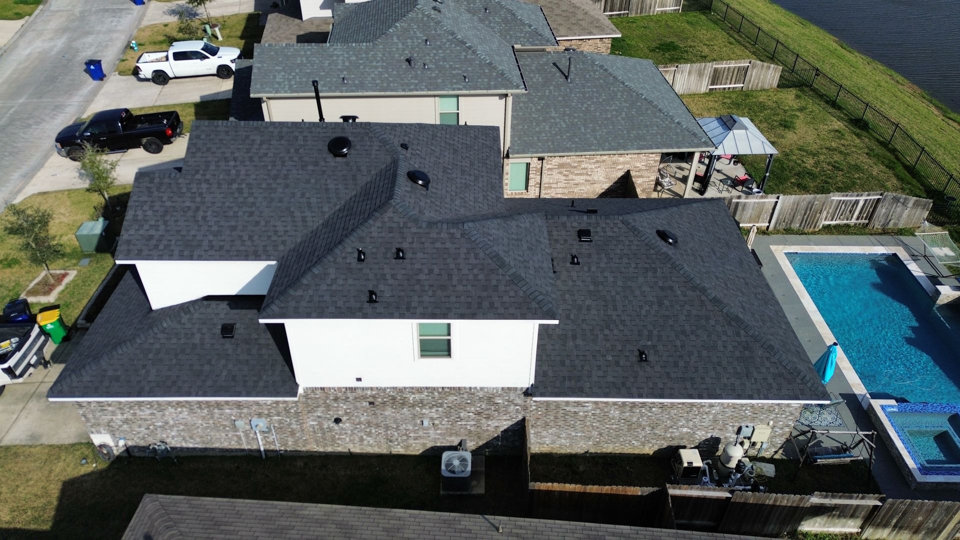 An aerial view of a house with a pool in the backyard.