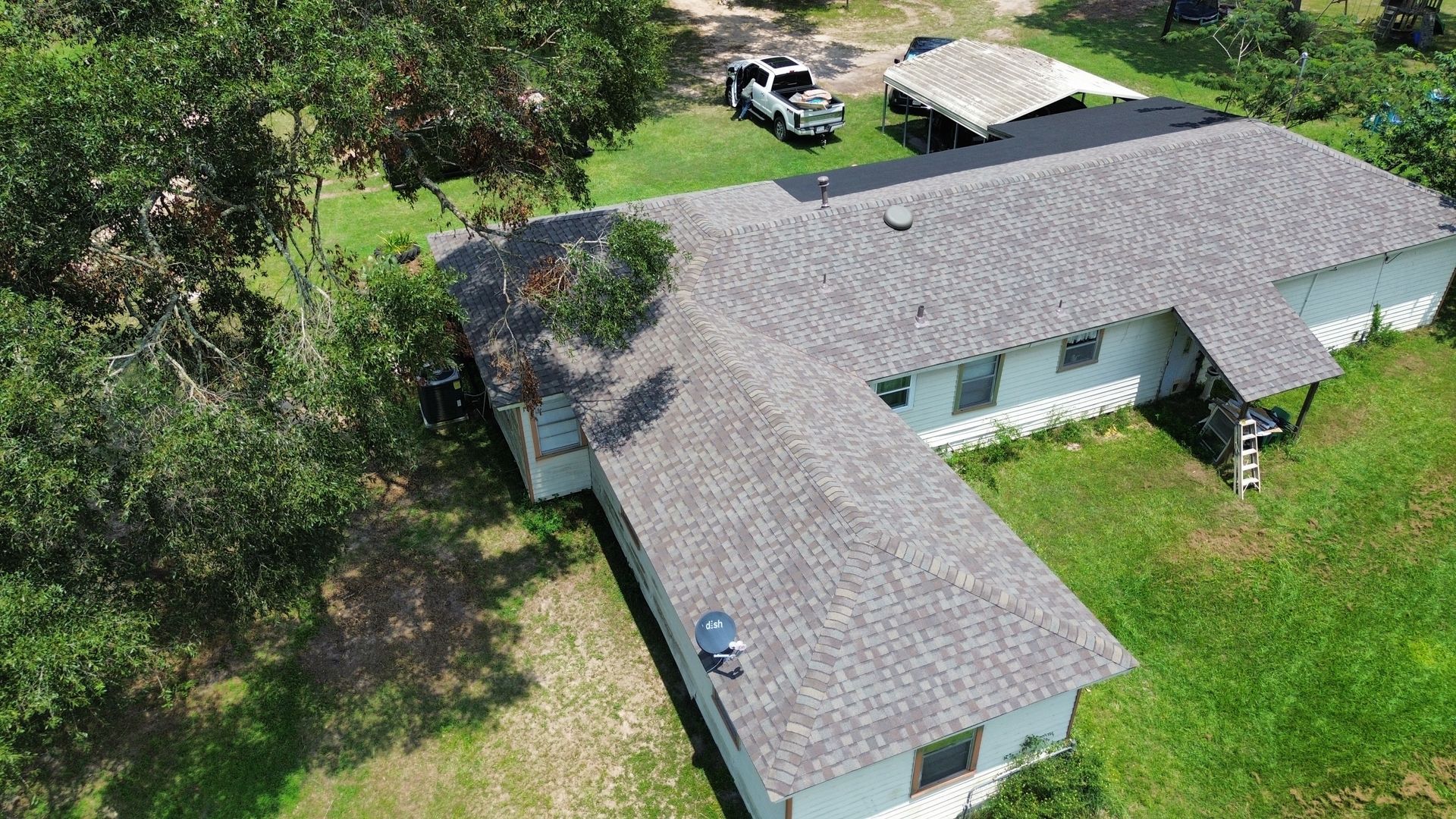 An aerial view of a house with a roof that is being installed.