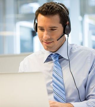 Staff wearing headset at office on phone - Technical Support in Murray, UT