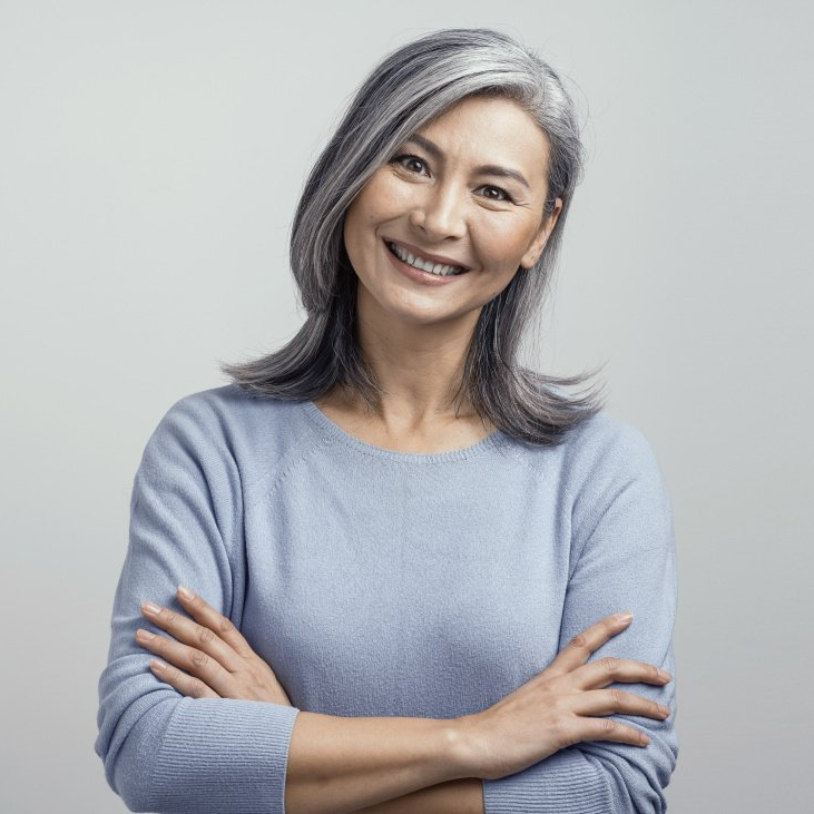 woman with gray hair looking forward smiling