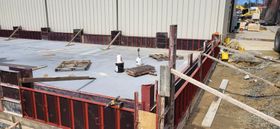 Construction site with concrete forms in place, preparing for a pour.