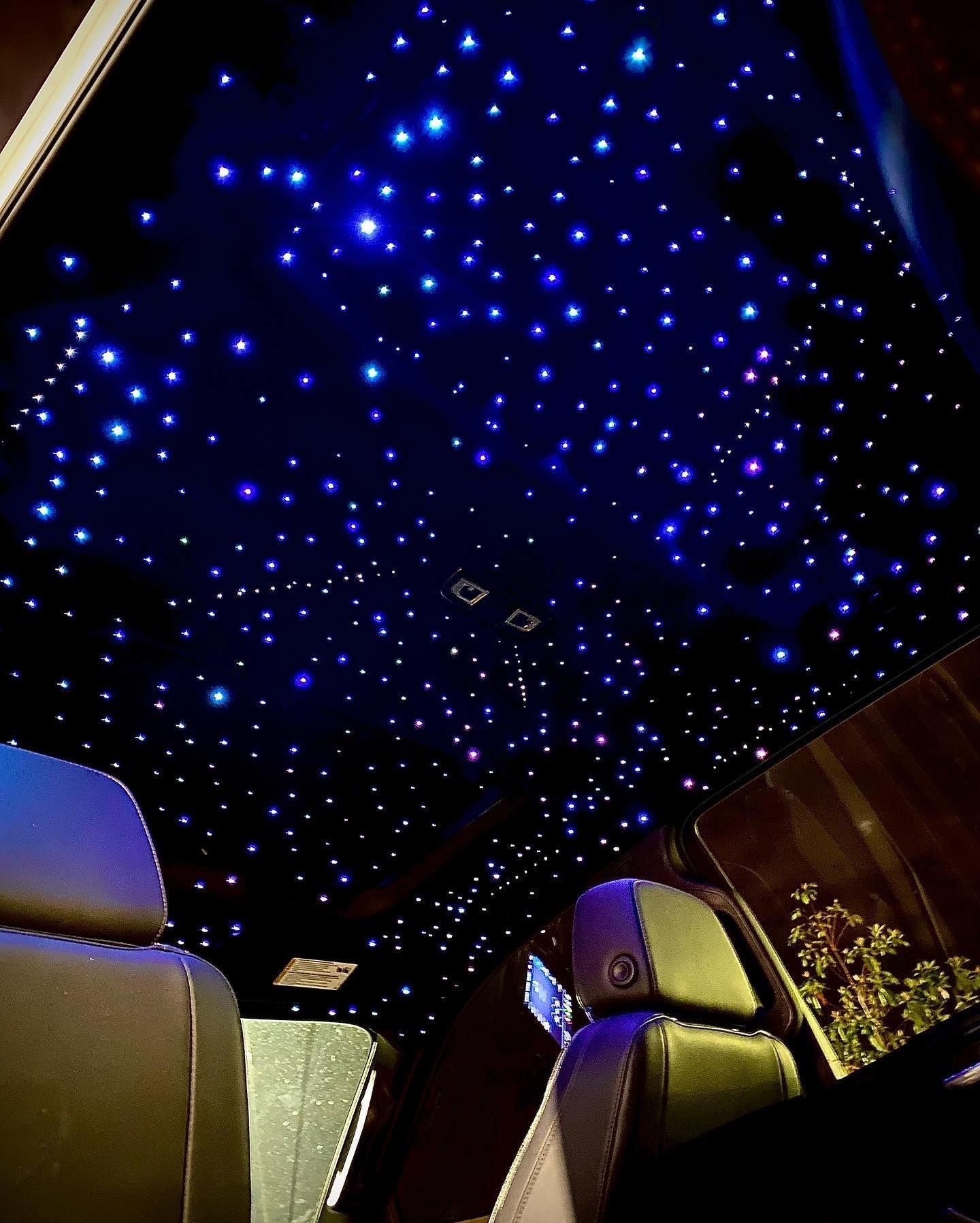 The ceiling of a car with a lot of stars on it
