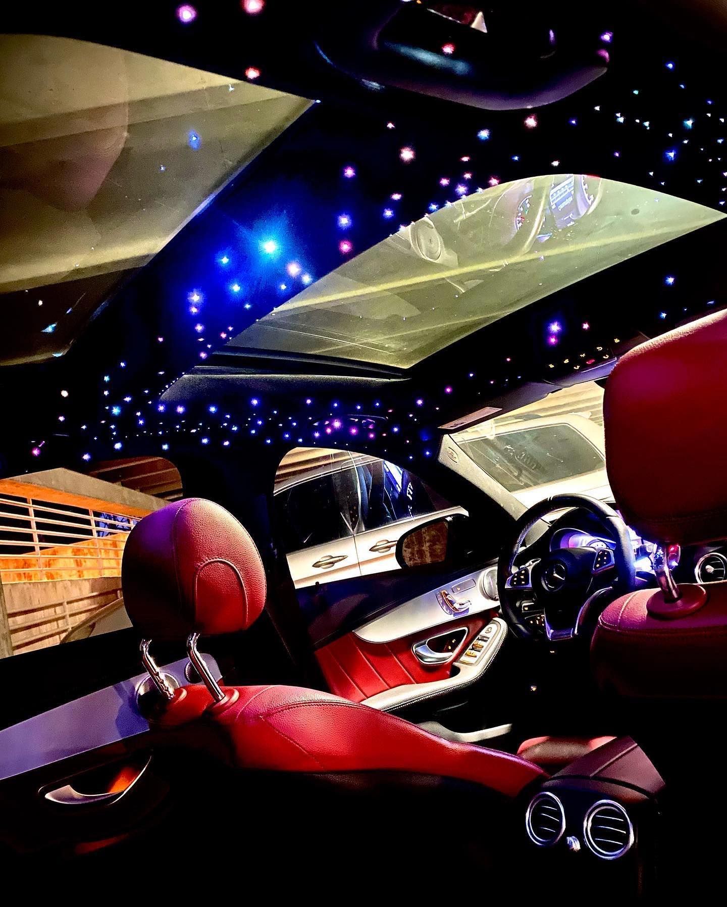 The inside of a car with a starry sky in the ceiling.