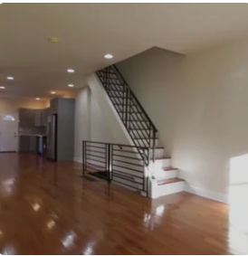 An empty house with stairs leading up to the second floor